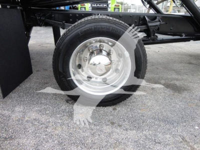Truck chassis with front wheel and hub visible; tire reads Goodyear? and componentry underframe with rollback truck. 