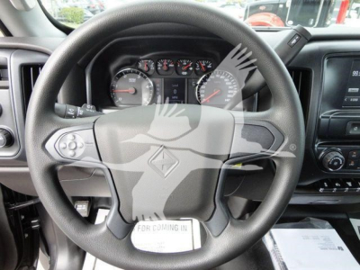 Wheel and dashboard of a new 2023 International CV truck showing steering wheel with logo and instrument cluster.