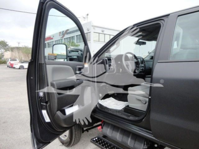 Truck cab interior with front left door open, showing dashboard, steering wheel, and seating; image branded with a watermark.