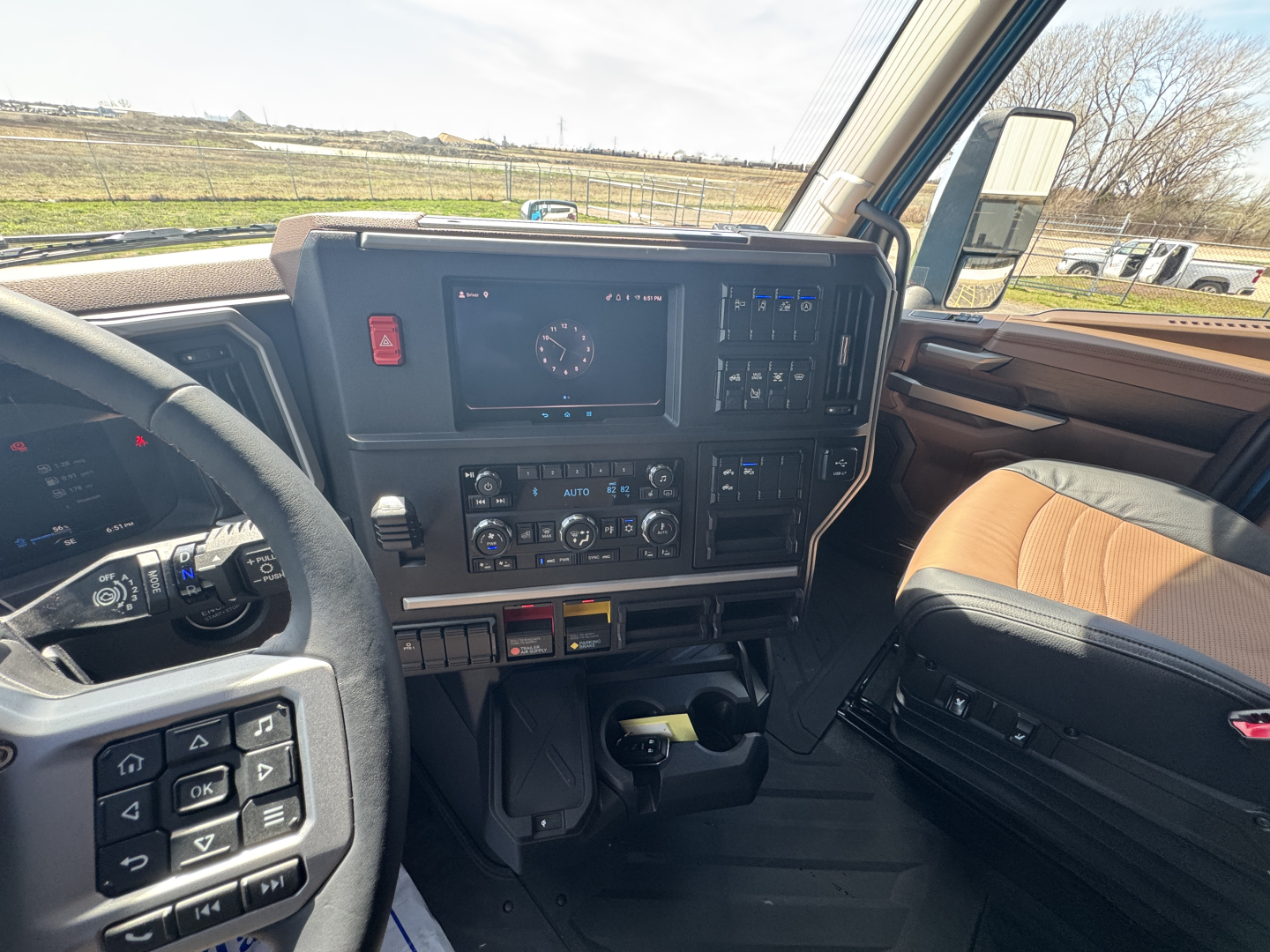 Dashboard and steering wheel area of a 2027 Mack AN64T64 truck cab. Visible texts include a central display and various control labels on the dashboard. No specific model text clearly legible beyond the overall vehicle interior.