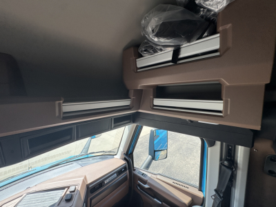 Mack AN64T64 truck cabin interior showing overhead compartments and tan interior panels.