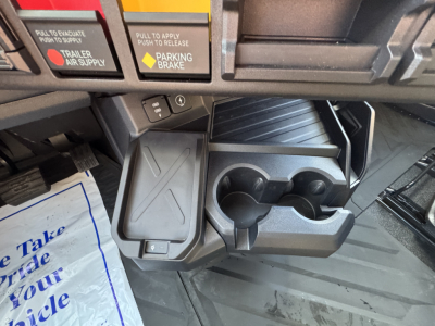 Dashboard area showing cup holders and center console with storage compartments and various switches.
