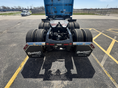 Front view of a Mack AN64T64 tractor with dual rear axles and fifth wheel, showing mud flaps with 'Beckner's' branding and chassis.