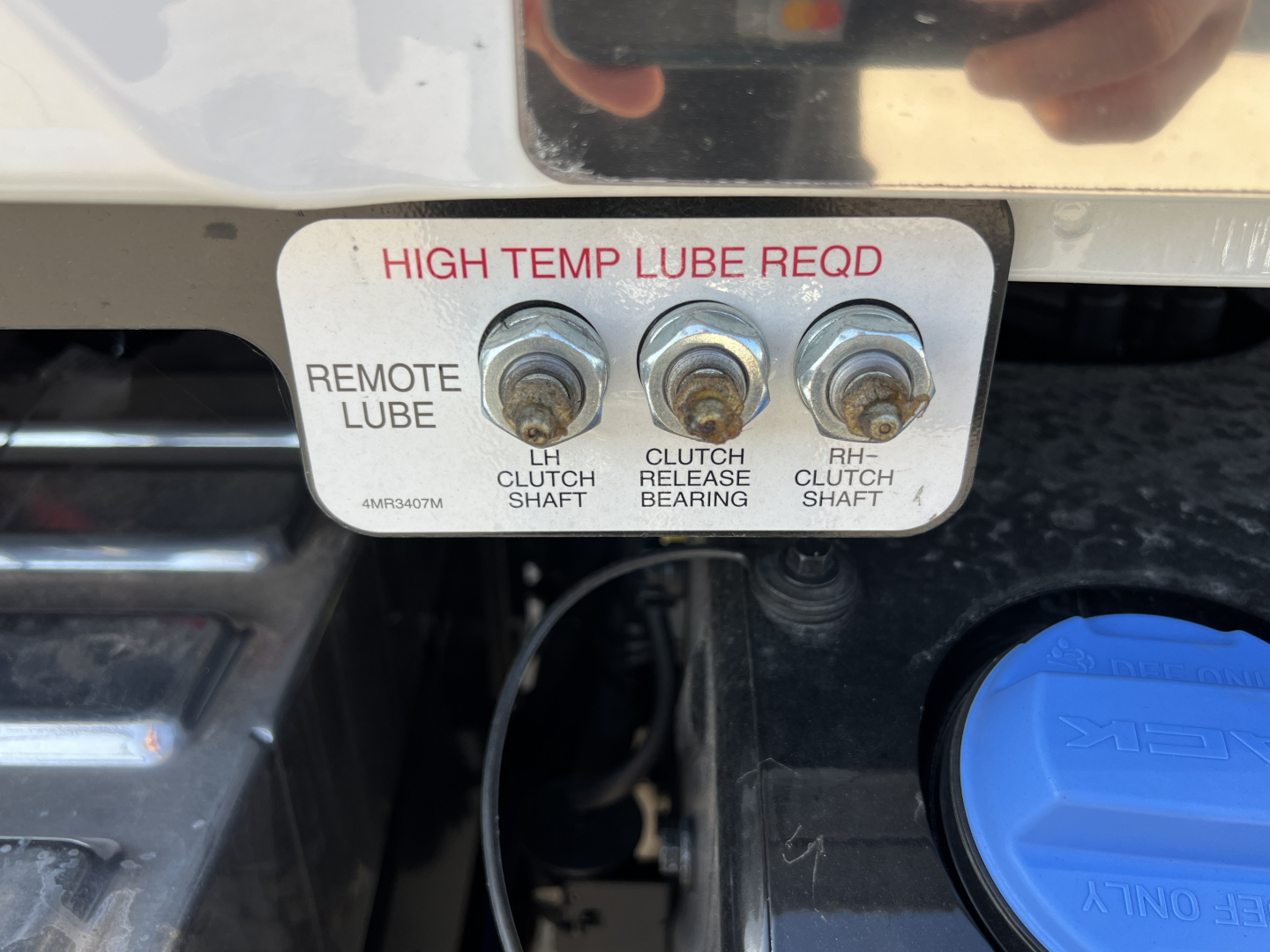 Plate showing high temp lube reqd with three bolts labeled LH clutch shaft, clutch release bearing, RH clutch shaft; blue reservoir cap nearby.