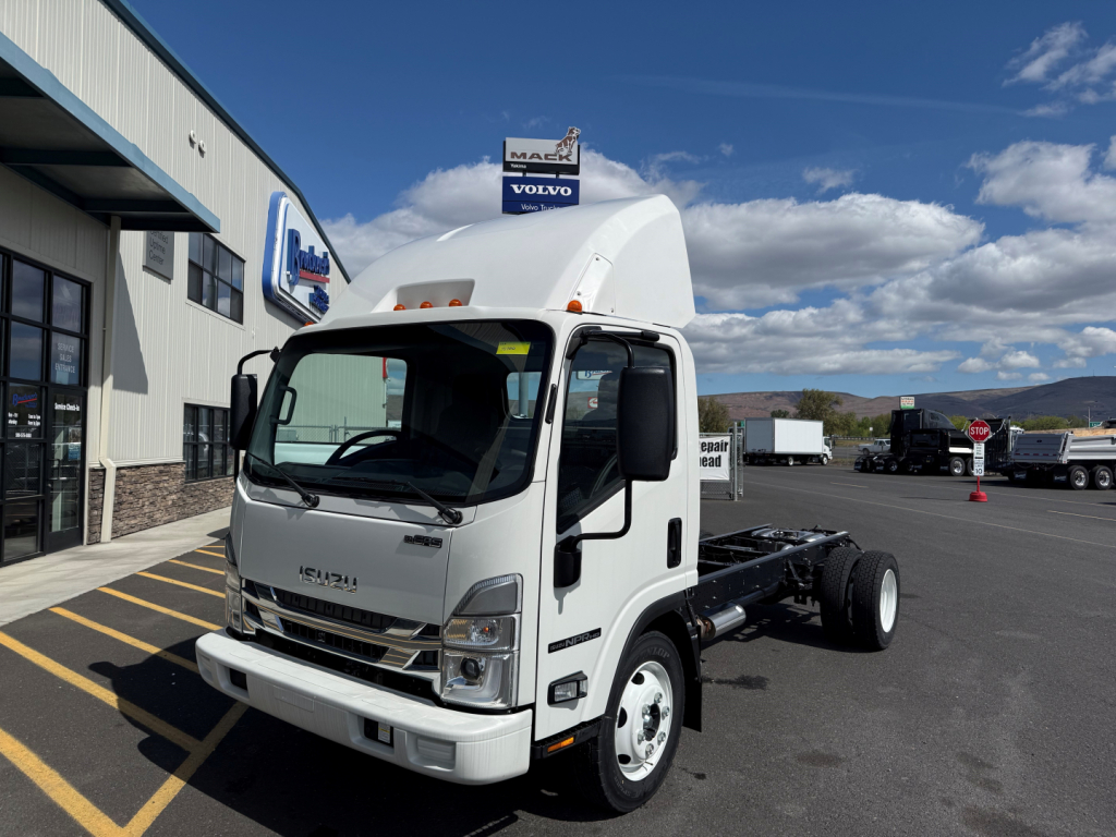 Isuzu NPRGASHD cab and chassis truck in a dealership lot with white cab, black chassis, and front view showing Isuzu emblem.