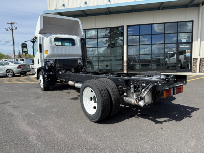 Isuzu NPRGASHD cab and chassis truck showing chassis frame and rear axle with dual rear wheels and exhaust pipe.