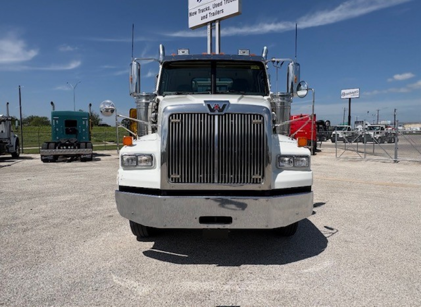 Front view of a white 2020 Western Star 4700SF conventional daycab truck with a large chrome grille and bumper.