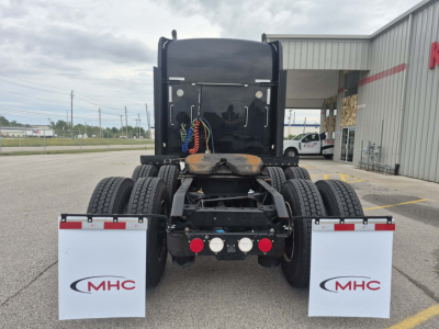 Kenworth W900L rear view showing fifth wheel, dual rear axles, and MHC mud flaps.