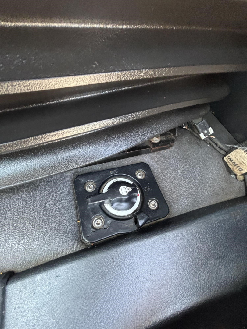 Truck interior showing fuel cap access panel and surrounding dash area.