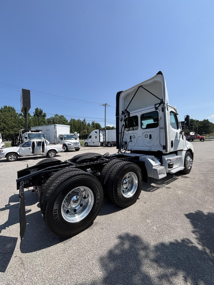 Freightliner Cascadia 126 semi truck chassis and cab shown from rear side in a parking lot