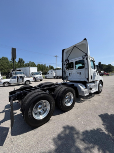 Freightliner Cascadia 126 semi truck chassis and cab shown from rear side in a parking lot