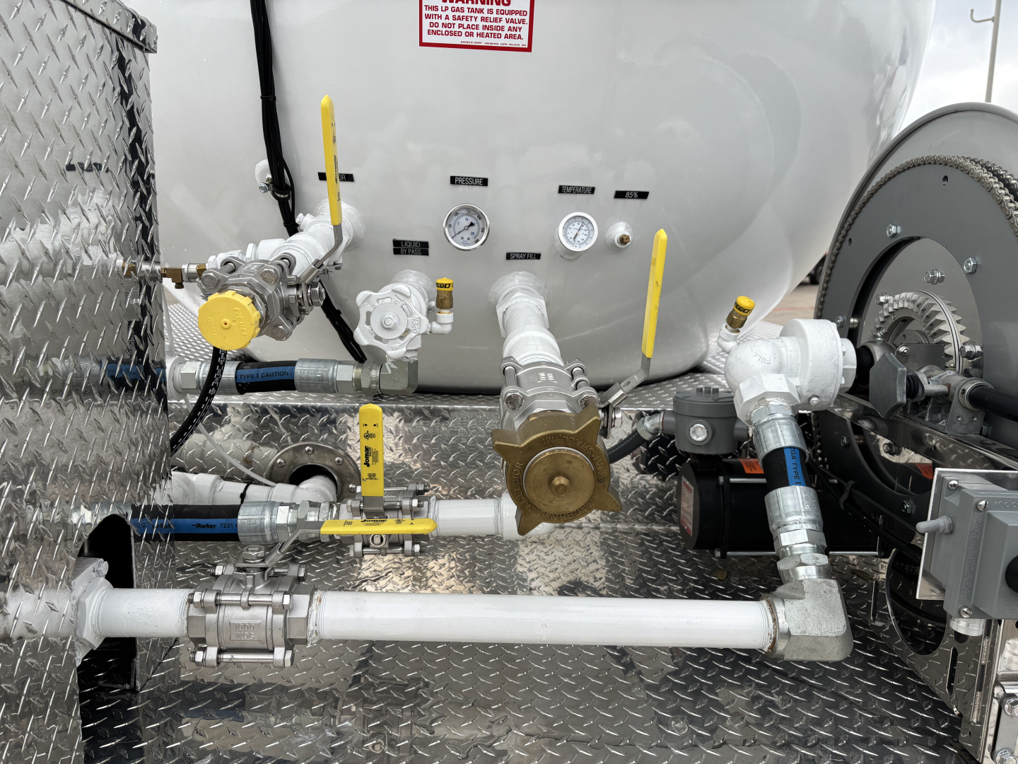 Mack MD7 truck component image showing fuel/air lines, valves, gauges, and piping arranged on a diamond-plate platform with yellow handles.