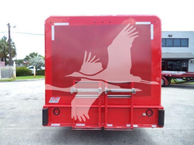 Truck rear view showing red beverage truck with white birds logo and back doors.
