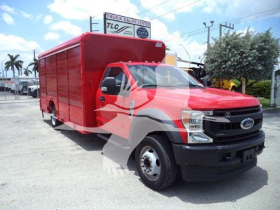 Ford F-550 box truck in red, front three-quarter view, with large cargo box on chassis and black bumper.