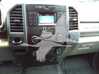 Ford F-550 cab interior center console with radio display and climate controls.