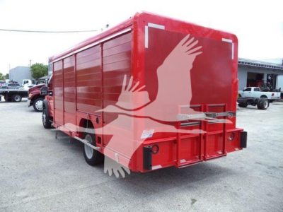 Red Ford F-550 box truck rear view with open rear doors and reflection of surroundings.