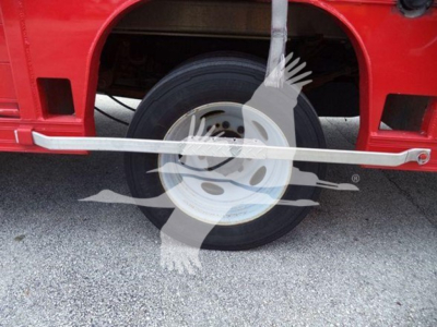 Ford F-550 wheel and part of red truck body with tire and white rim; no legible technical labels visible.