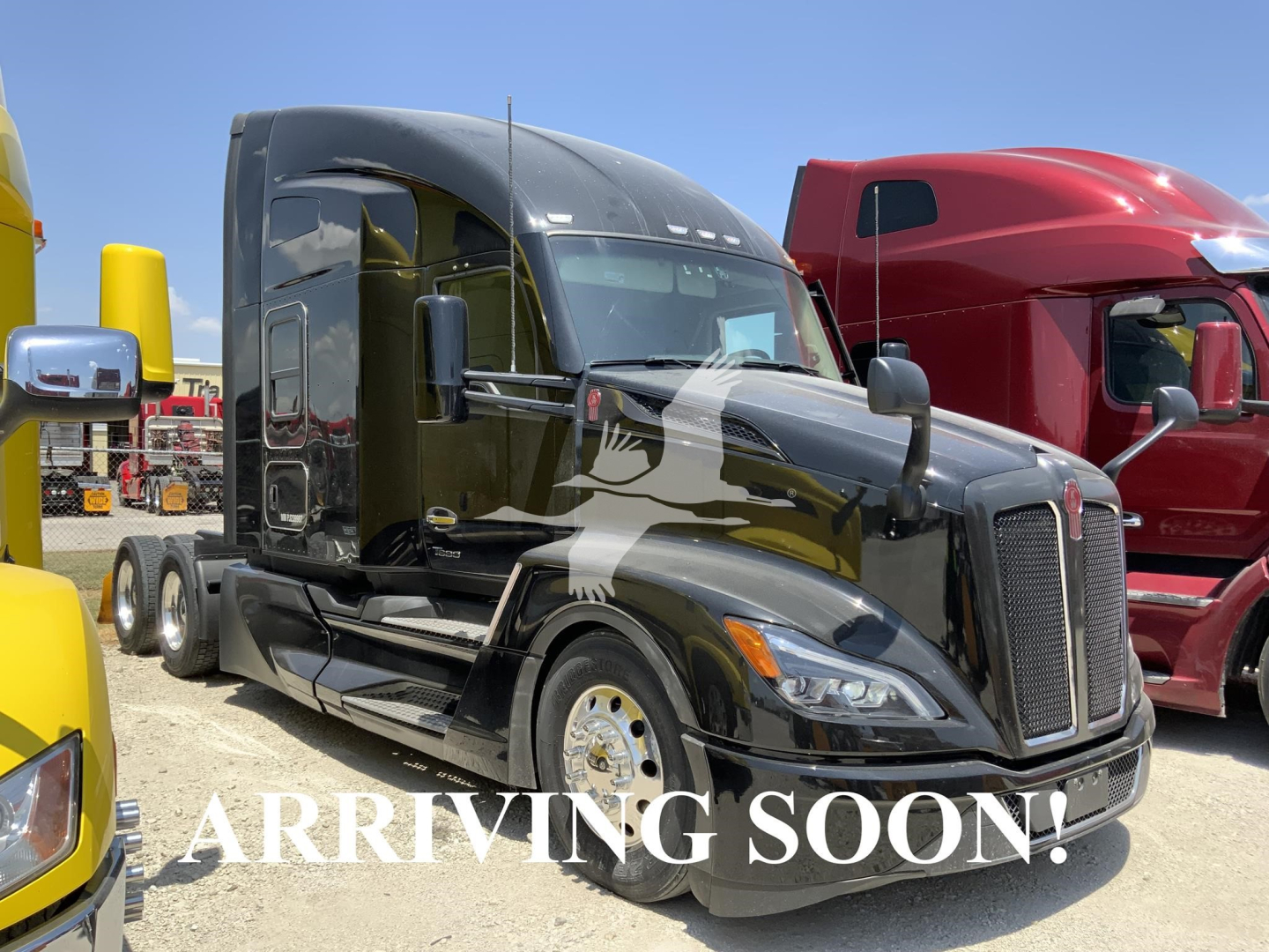 Kenworth T680 cab in black showing front grille, headlights, and mirrors; text overlay 'ARRIVING SOON!'