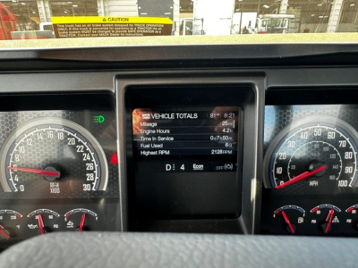 Mack GR64F dash cluster showing vehicle totals on center display with speedometer on right and tachometer left.