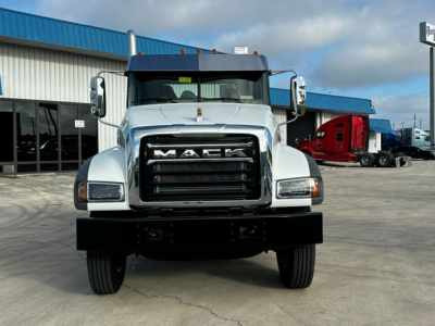 Mack GR64F dump truck front view showing bold grille with MACK lettering and large bumper.