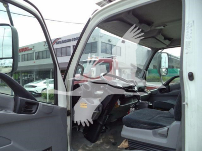 Cab interior of a 2019 Hino 195 refrigerated truck showing steering wheel, dashboard, and driver seat with open passenger-side door.