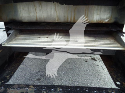 Rear interior step area of a refrigerated 2019 Hino 195 showing a metal step and floor with some dark stains.