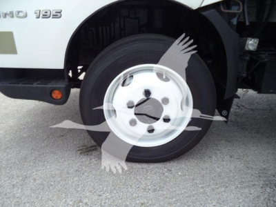 Front wheel and side of 2019 Hino 195 refrigerated truck showing wheel and partial cab with '195' badge.