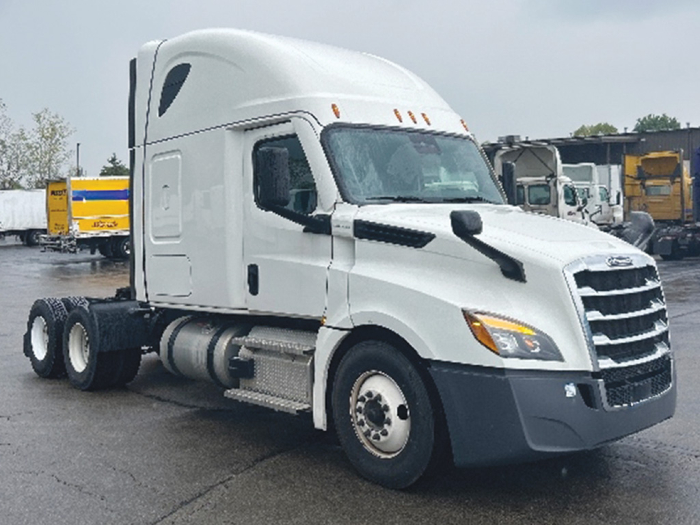 Truck cab side view of a 2022 Freightliner Cascadia126 conventional sleeper with a white exterior and dual rear axles.