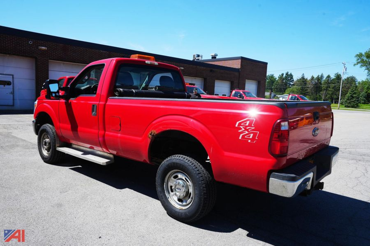 Red 2016 Ford F-350 XL SD dually pickup with plow, rear three-quarter view, 4x4 badge visible, chrome bumper, utility bed area, dealership lot