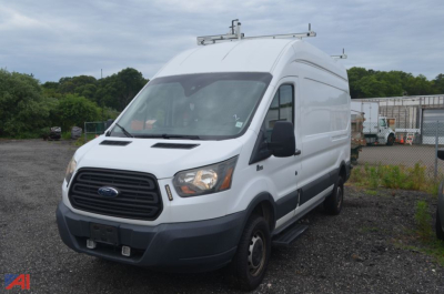 Ford Transit 2016 cargo van viewed from passenger side with roof rack and ladder rails.
