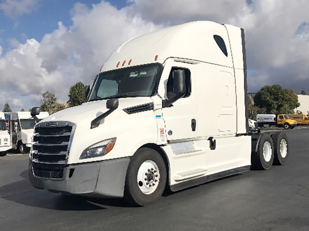 Freightliner Cascadia125 truck from a side-front angle showing sleeper cab and white exterior with large grille.
