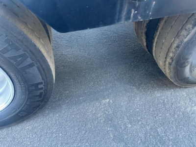 Kalyn Siebert lowboy trailer wheel and tires visible in front showing dual axle configuration