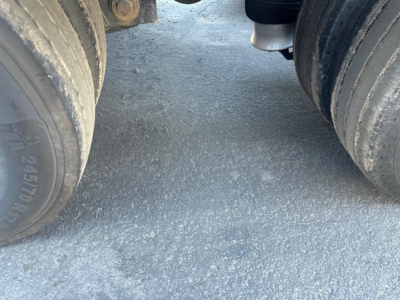 Kalyn Siebert lowboy trailer wheels and frame showing dual tires and axle area.