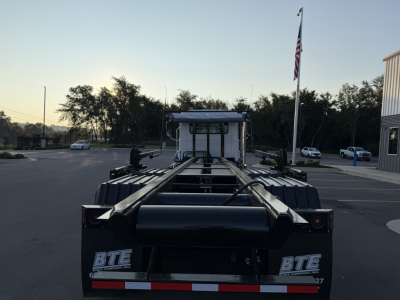 Dump truck chassis rear view showing BTE Equipment logo and frame rails of a 2027 Mack GR64B roll-off truck.