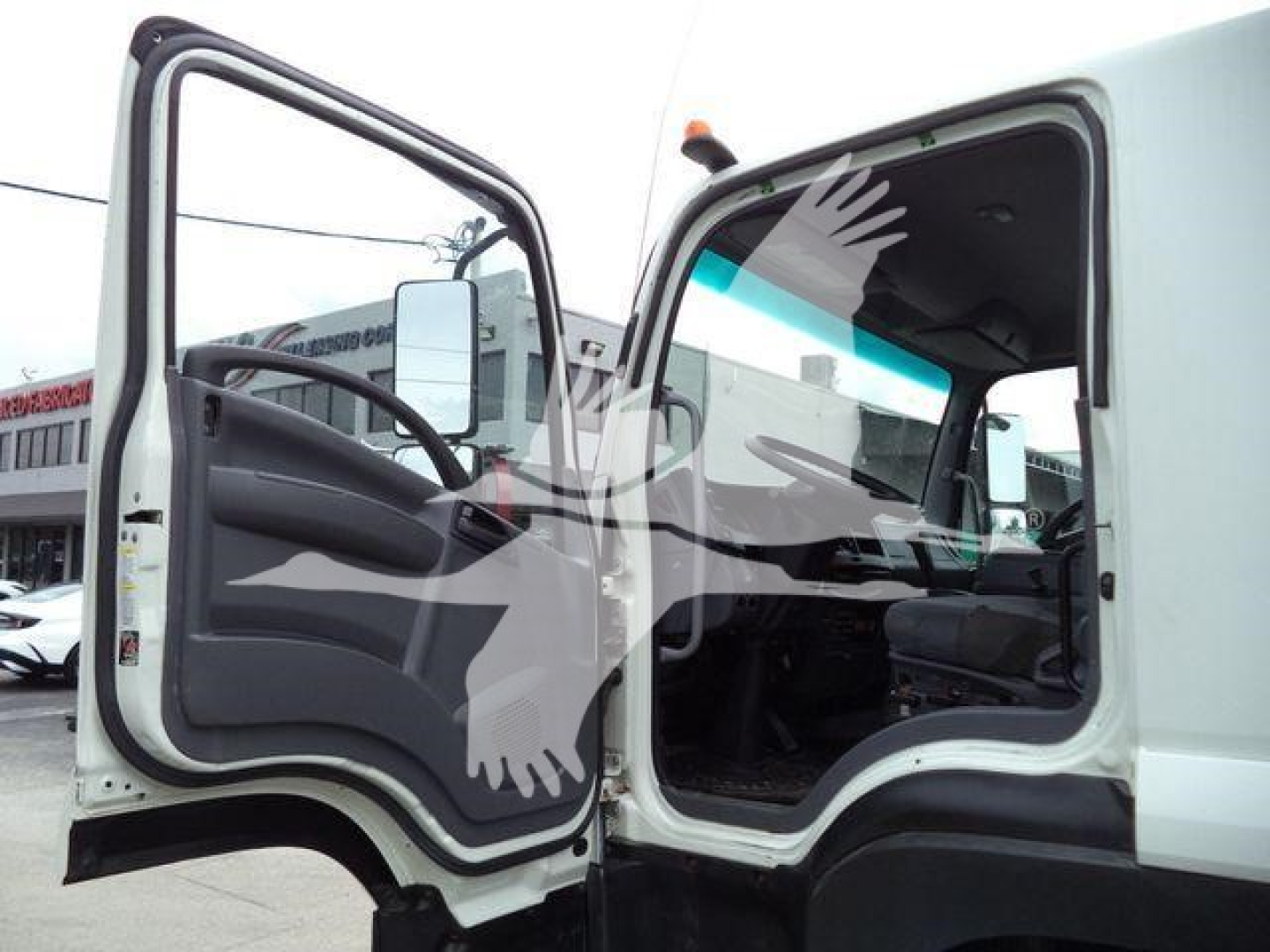 Isuzu 2018 FTR cab interior and open door showing dashboard and steering wheel.