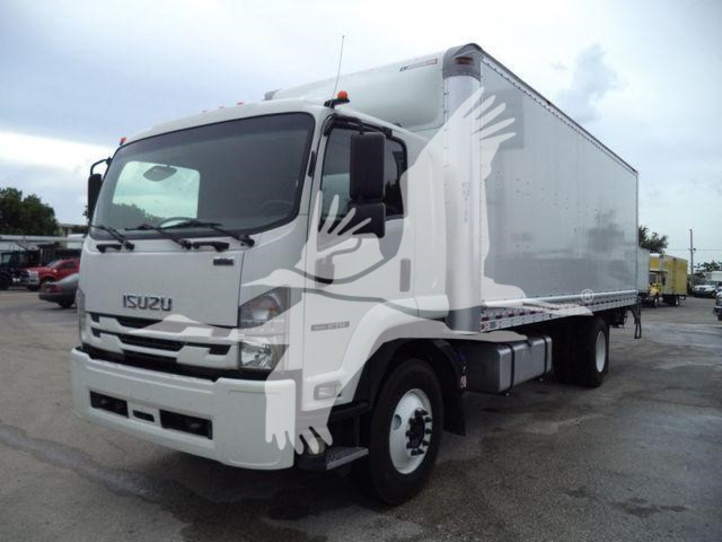 Isuzu box truck in driver’s side view showing cab and cargo box with Isuzu logo on grille.