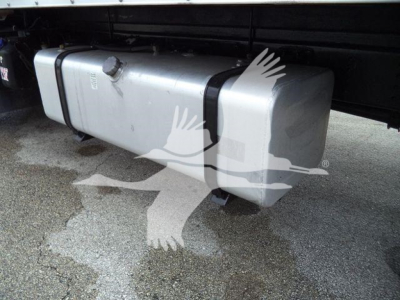 Isuzu box truck undercarriage showing a rectangular aluminum fuel tank or auxiliary tank with two black straps; writing on tank appears blurred.