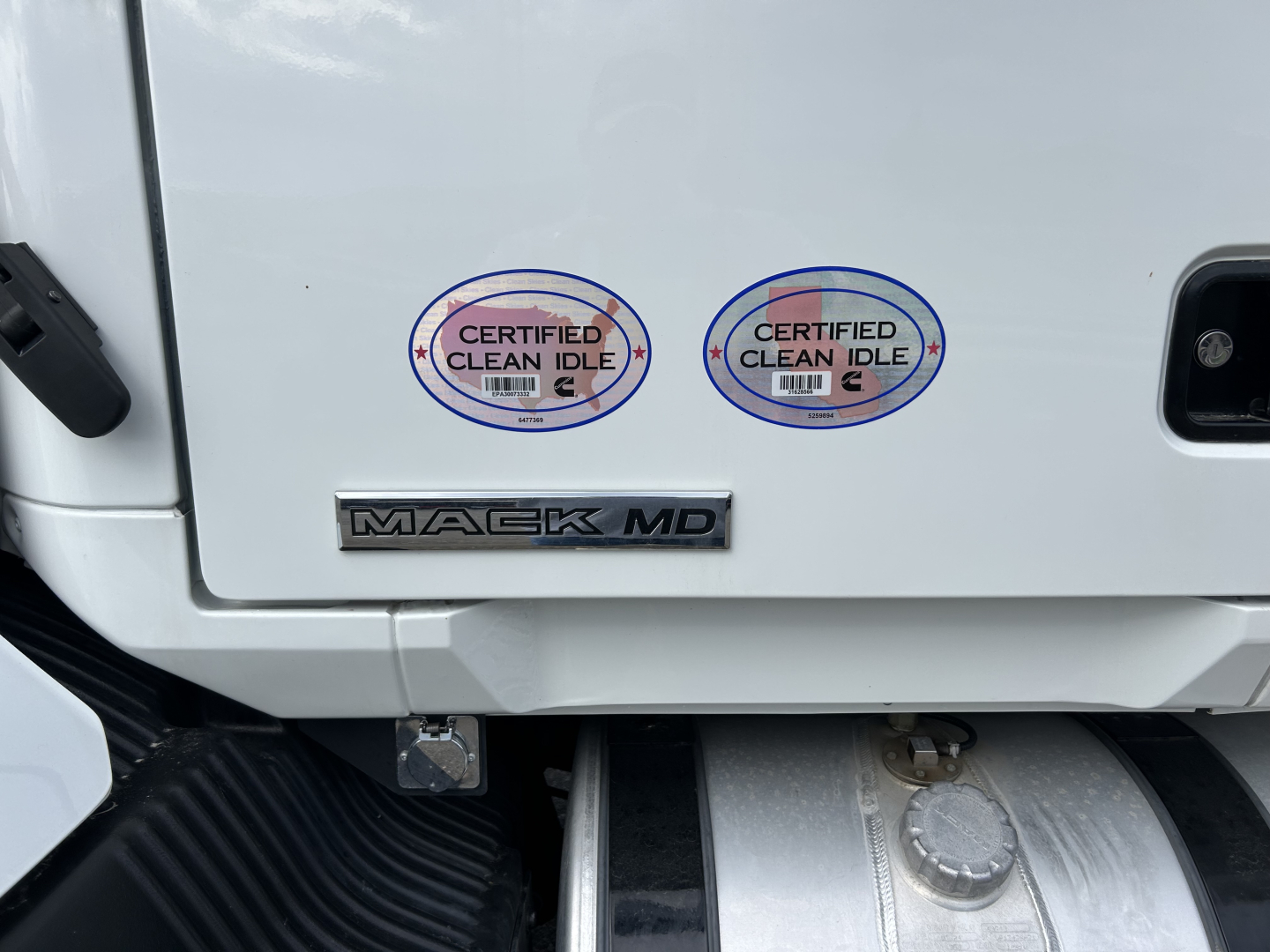 Mack MD7 truck rear door area showing two Certified Clean Idle stickers and Mack MD badge.