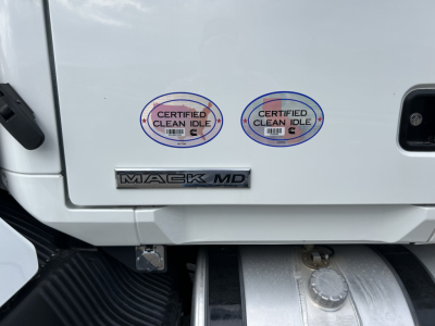Mack MD7 truck rear door area showing two Certified Clean Idle stickers and Mack MD badge.