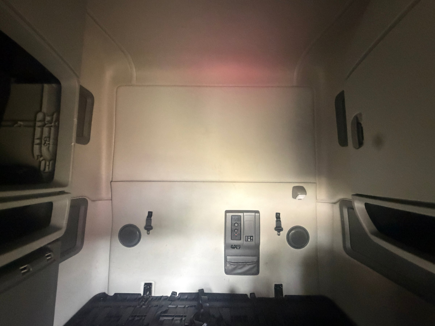 Volvo VNL64T760 sleeper truck cab interior rear wall with control panel and circular ports.