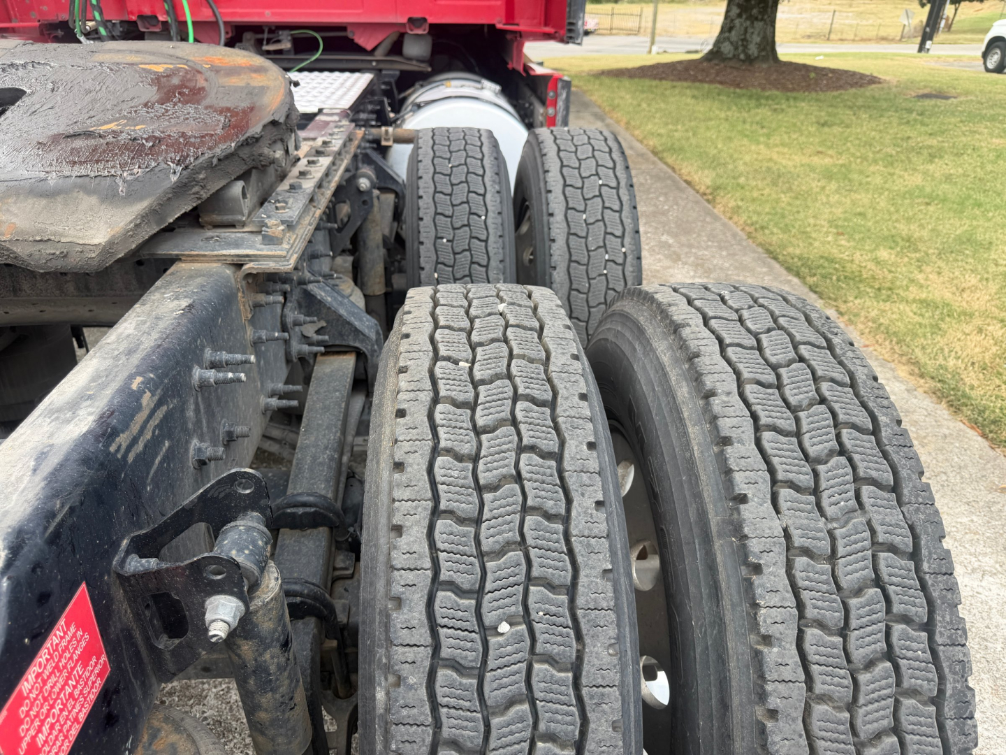 Volvo VNL64T760 tractor-trailer chassis in-service showing dual rear axles and tire tread pattern.