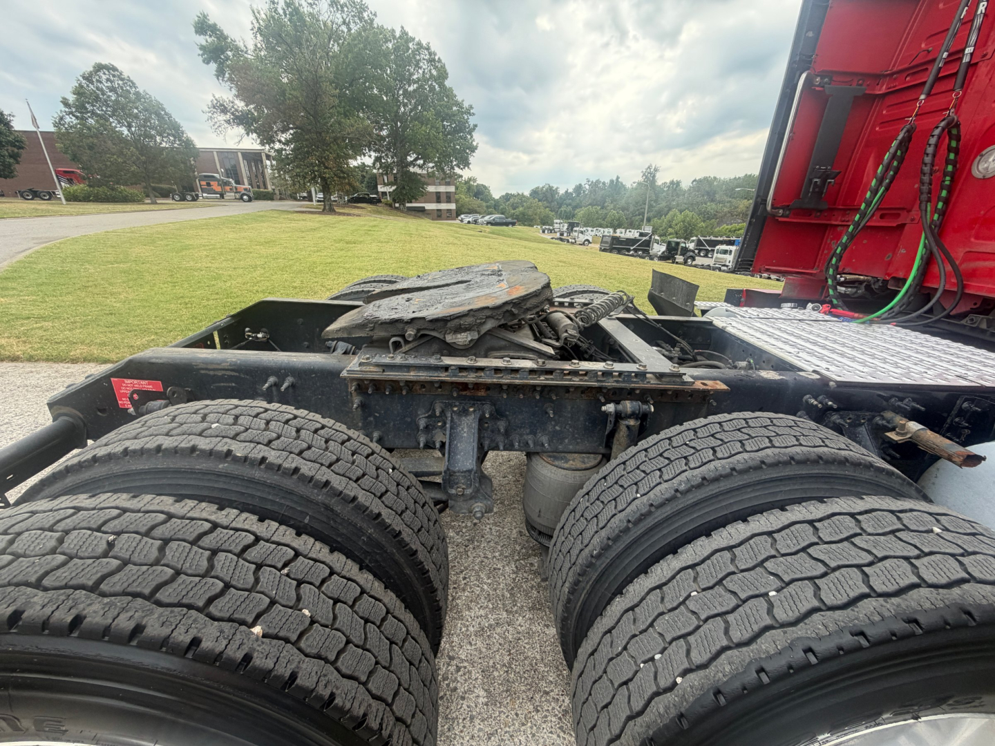 Rear view of a Volvo VNL truck chassis showing dual rear axles with heavy tires and fifth-wheel coupling area