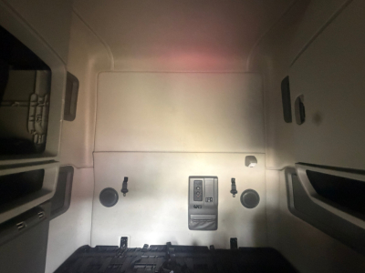 Volvo VNL64T760 sleeper truck cab interior rear wall with control panel and circular ports.