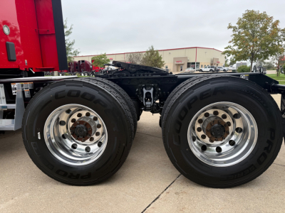 Kenworth T680 chassis showing dual rear wheels and Goodyear tires, chrome rims, undercarriage with fifth wheel and frame rails visible.