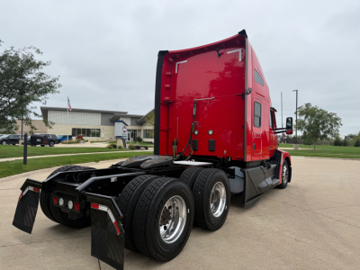 Kenworth T680 tractor, red sleeper cab, rear view showing dual rear axles and fifth-wheel, no visible text on components.