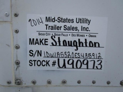Vehicle trailer door with a label: '2014 Mid-States Utility Trailer Sales, Inc.' Make Stoughton, S/N 1DW1A5320ES435912, STOCK # U90973, handwritten '2014' and other details.