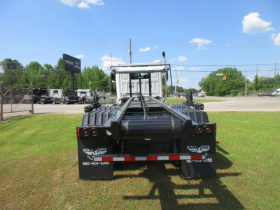 Western Star 47X roll-off truck rear view showing chassis and mud flaps with Roll Offs branding and contact numbers.