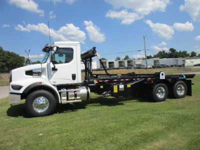 Western Star 47X roll-off truck in white with third-axle and hook lift, side view