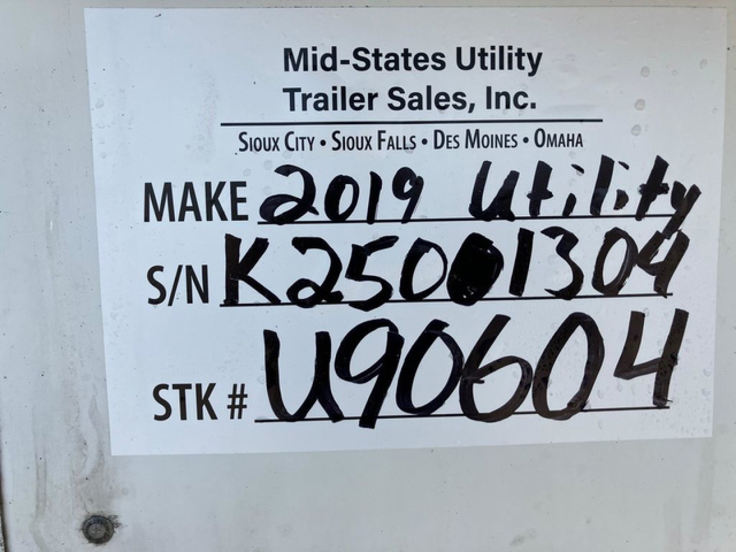 Plate-style label on trailer showing Mid-States Utility Trailer Sales, make 2019 Utility, S/N K25001304, STK # U906604, VIN 1UYVS2534K2501304, stock U90604, S/N handwritten.