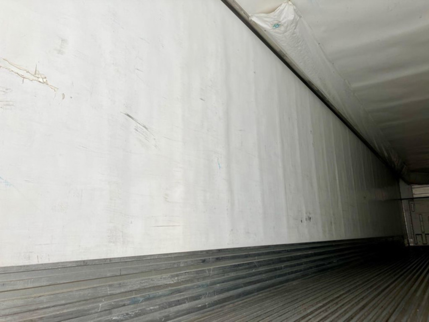 Trailer interior wall and cargo area of a 2019 Utility Reefer showing aluminum sidewall and ribbed floor.
